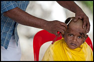 Young Boy Getting  Haircut, Thaipusam, Malaysia